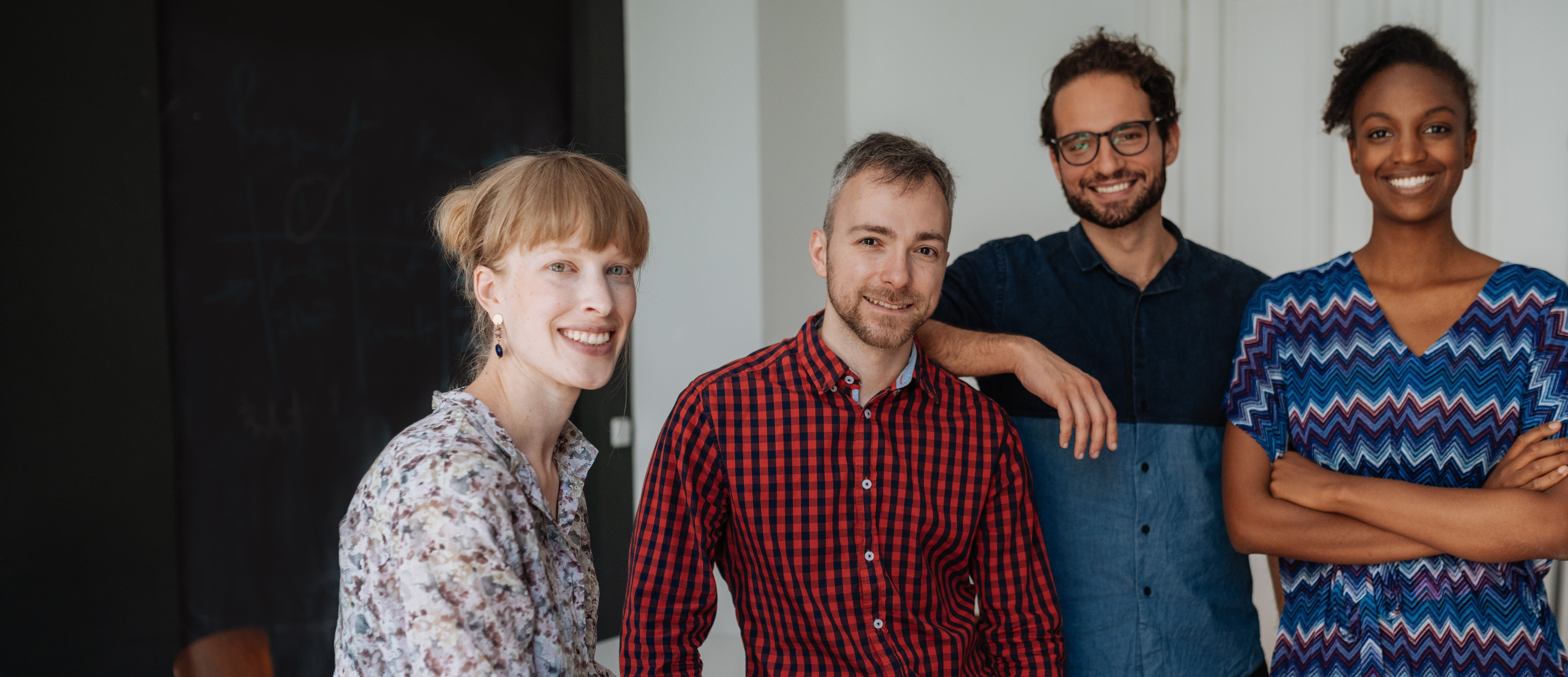 Two men and two women smiling