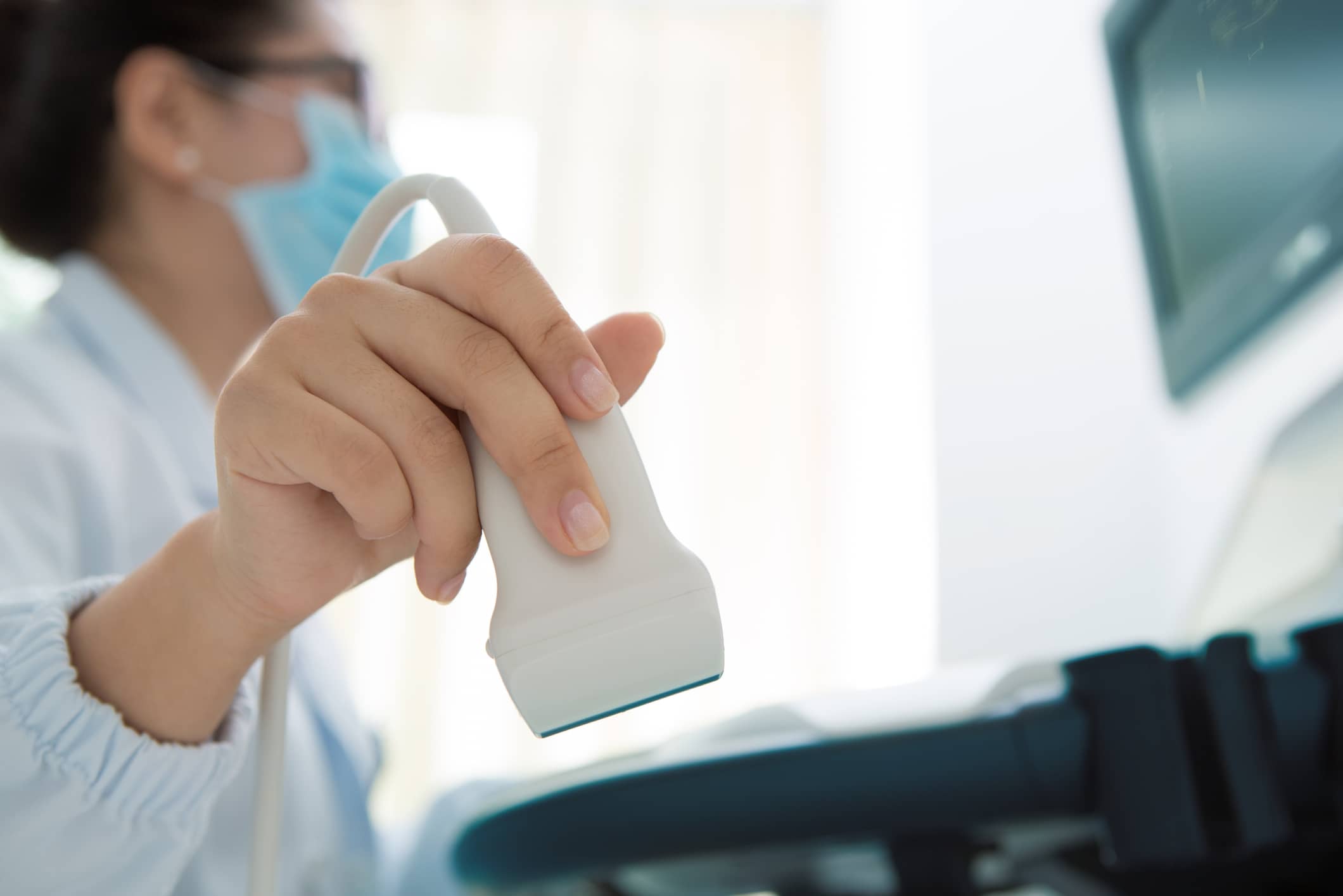 Woman giving performing an ultrasound on a patient