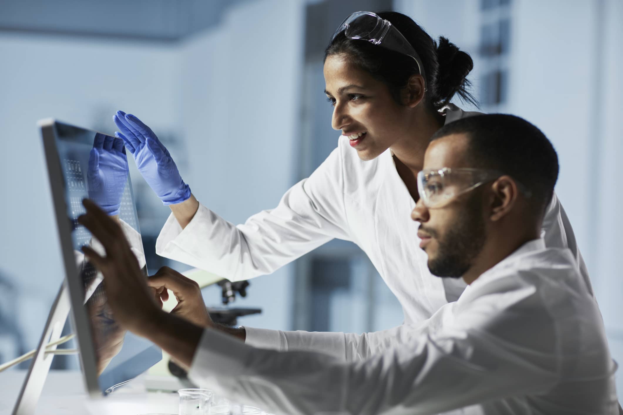 Lab techs reviewing labs on a computer