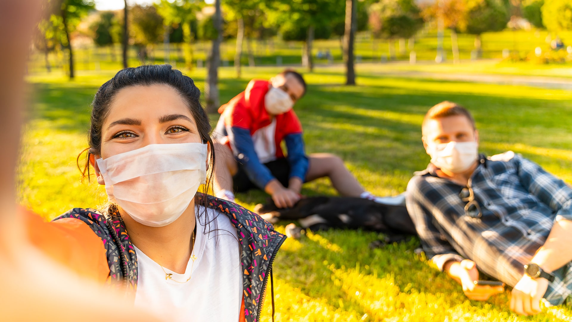 Allied health travel professionals on their lunch break in the grass