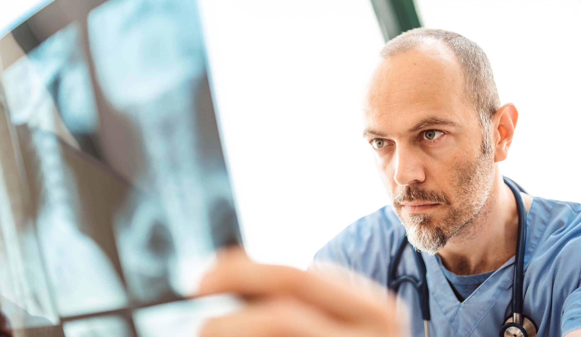 Pulmonary function technician looking at x ray